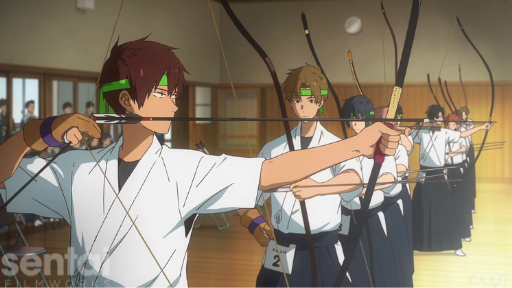 A row of archers from the Tsurune anime stand in a line at a competition, holding bows aloft in various stages of firing.