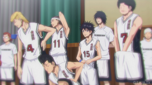 The basketball team of Kuzu High stands at attention in their white uniforms with red numbers of the front.